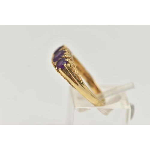 90 - AN 18CT GOLD THREE STONE RING, three round cut amethysts, prong set in yellow gold, scrolling detail... 