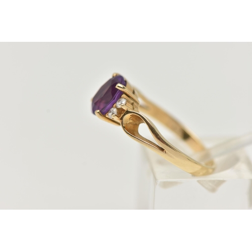 98 - AN AMETHYST DRESS RING, a principally set oval cut amethyst with four round cut cubic zirconia, lead... 