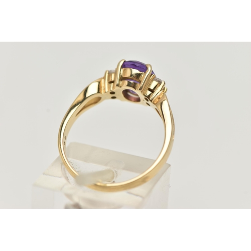 98 - AN AMETHYST DRESS RING, a principally set oval cut amethyst with four round cut cubic zirconia, lead... 