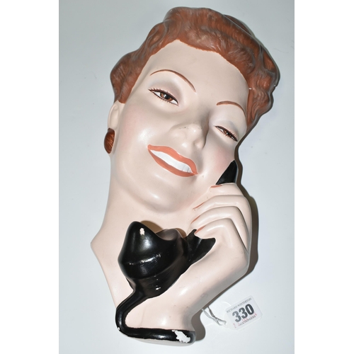 330 - A LARGE PLASTER WALL PLAQUE OF A 1940S STYLE YOUNG WOMAN WITH A TELEPHONE, height 37.5cm x width 20c... 