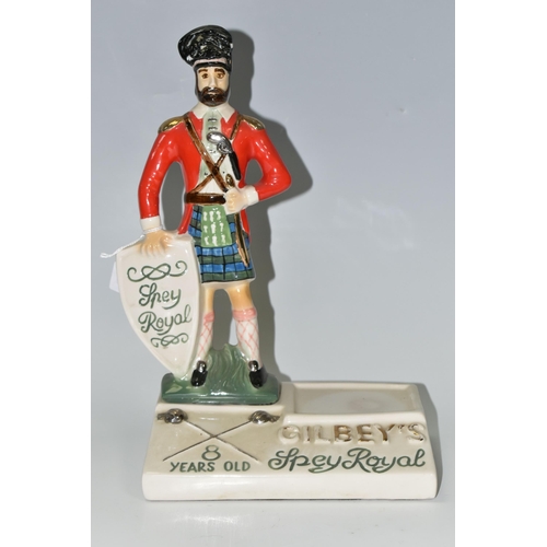 338 - BREWERIANA: A GILBEY'S SPEY ROYAL WHISKY CERAMIC ADVERTISING STAND, a Staffordshire style Highland r... 