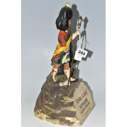 344 - BREWERIANA: A WHITE LABEL DEWAR'S SCOTCH WHISKY ADVERTISING FIGURE, comprising a rubberoid Scots Gua... 