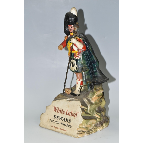 344 - BREWERIANA: A WHITE LABEL DEWAR'S SCOTCH WHISKY ADVERTISING FIGURE, comprising a rubberoid Scots Gua... 