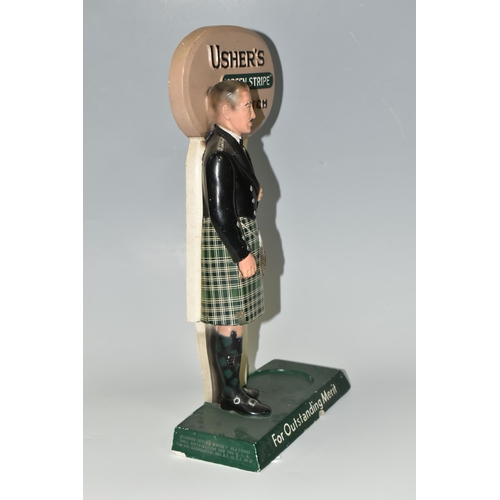 348 - BREWERIANA: AN USHER'S GREEN STRIPE SCOTCH ADVERTISING  BOTTLE STAND, cast plaster figure of a Highl... 