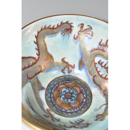 373 - A WEDGWOOD DRAGON LUSTRE WARE PEDESTAL BOWL,  in pattern no Z4831, the interior decorated with a red... 