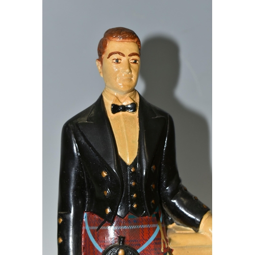 396 - A GLENFIDDICH SCOTCH WHISKY ADVERTISING FIGURE, the chalkware figure in the form of a Scotsman leani... 