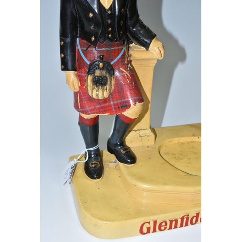 396 - A GLENFIDDICH SCOTCH WHISKY ADVERTISING FIGURE, the chalkware figure in the form of a Scotsman leani... 