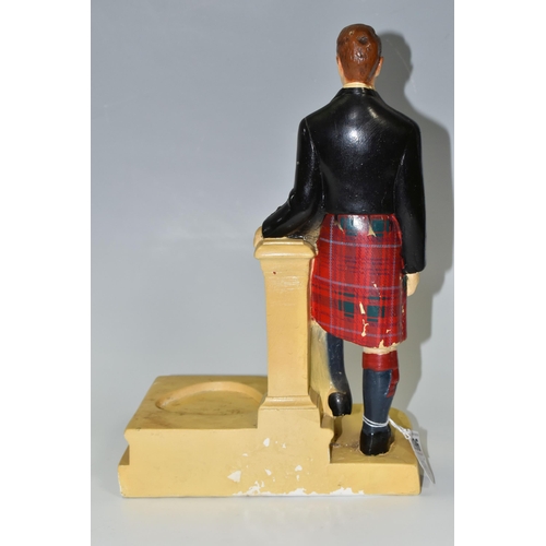 396 - A GLENFIDDICH SCOTCH WHISKY ADVERTISING FIGURE, the chalkware figure in the form of a Scotsman leani... 