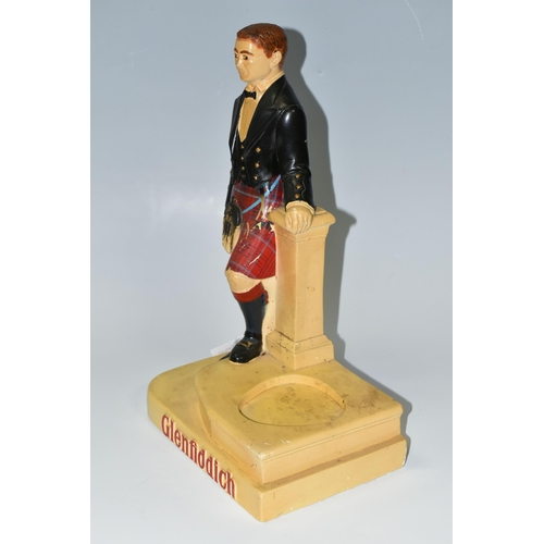 396 - A GLENFIDDICH SCOTCH WHISKY ADVERTISING FIGURE, the chalkware figure in the form of a Scotsman leani... 