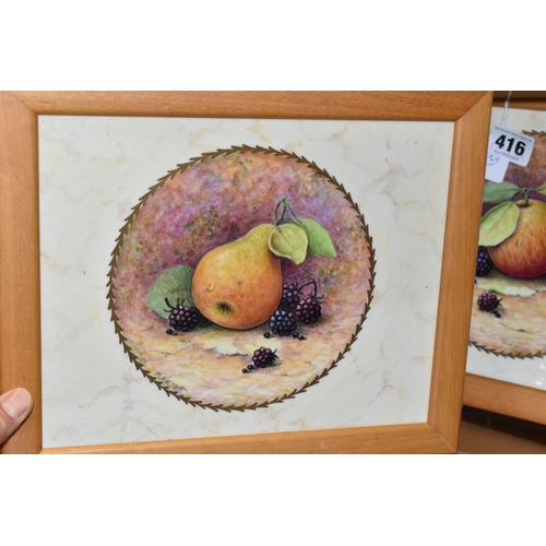 416 - TWO FRAMED HAND PAINTED CERAMIC PLAQUES, signed M. Harnett, painted with fruit in a central circular... 