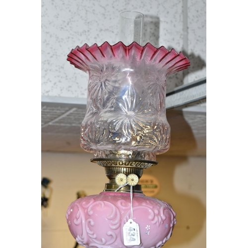 434 - A TALL VICTORIAN BRASS OIL LAMP, with a pink glass reservoir, clear to cranberry frilled shade, Dupl... 