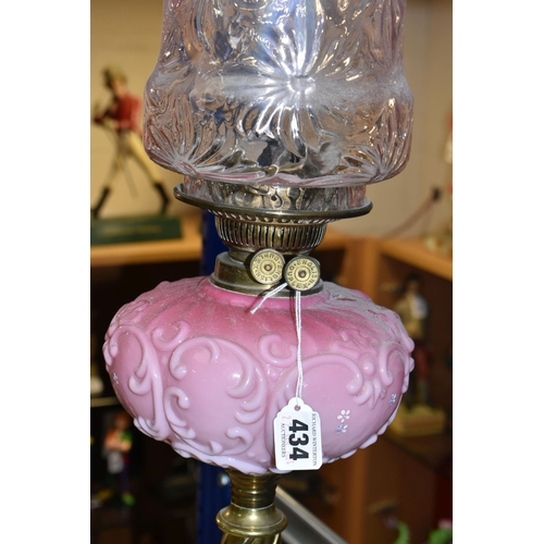 434 - A TALL VICTORIAN BRASS OIL LAMP, with a pink glass reservoir, clear to cranberry frilled shade, Dupl... 