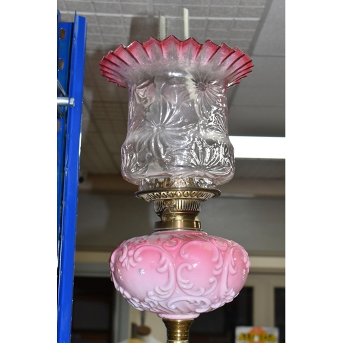 434 - A TALL VICTORIAN BRASS OIL LAMP, with a pink glass reservoir, clear to cranberry frilled shade, Dupl... 