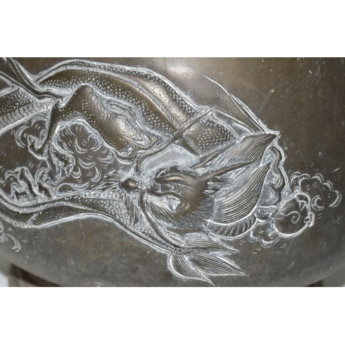 435 - AN ORIENTAL BRONZE PLANTER, decorated with a repoussé Japanese three clawed dragon on two sides and ... 