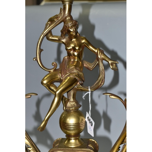 469 - A LARGE BRASS FIGURAL TABLE LAMP, with three bulb fittings at the top, brass gimble and two flame fo... 