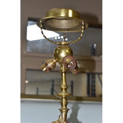 469 - A LARGE BRASS FIGURAL TABLE LAMP, with three bulb fittings at the top, brass gimble and two flame fo... 