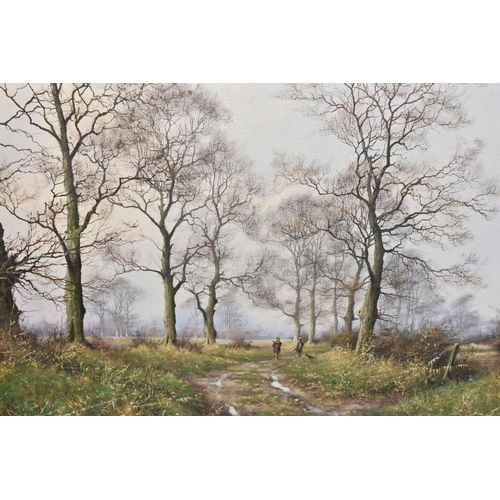 479 - JAMES WRIGHT (1935-) A MODERN ENGLISH SCHOOL LANDSCAPE, two figures and a gundog are standing on a p... 