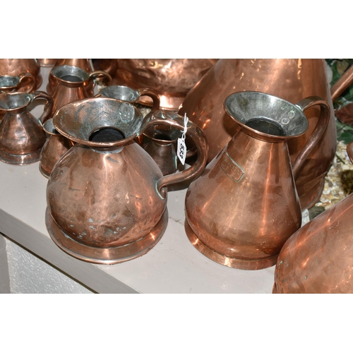 533 - SIXTEEN COPPER JUGS, stamped with measurements, from 1/2 Gill to 5 Gallons, and weights and measures... 