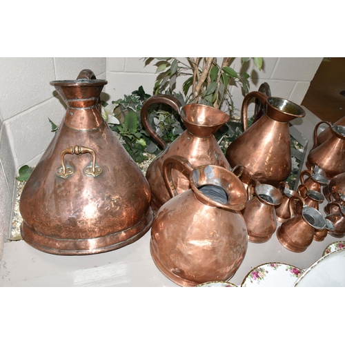 533 - SIXTEEN COPPER JUGS, stamped with measurements, from 1/2 Gill to 5 Gallons, and weights and measures... 