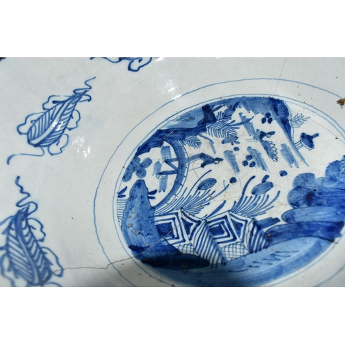 525 - A GROUP OF NAMED CERAMICS, comprising a large Delftware bowl, decorated with an Oriental water garde... 