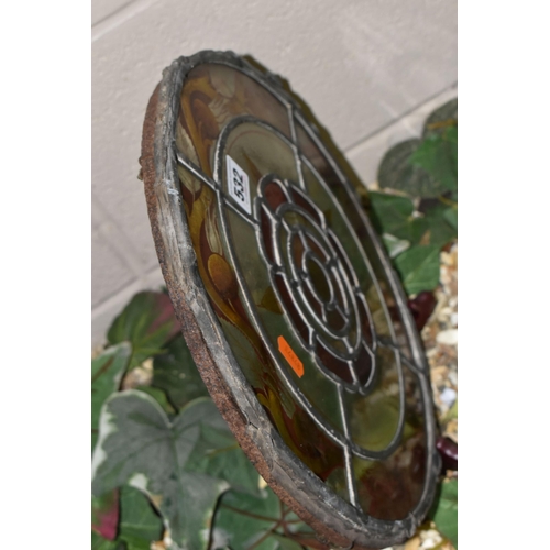 532 - A CIRCULAR STAINED GLASS PANEL, on a metal frame, decorated with a central Tudor rose motif, inside ... 