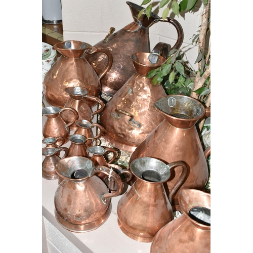 533 - SIXTEEN COPPER JUGS, stamped with measurements, from 1/2 Gill to 5 Gallons, and weights and measures... 