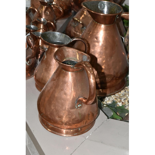 533 - SIXTEEN COPPER JUGS, stamped with measurements, from 1/2 Gill to 5 Gallons, and weights and measures... 