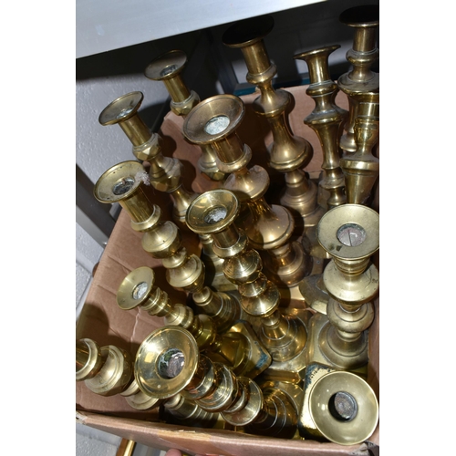 550 - TWO BOXES OF BRASS CANDLESTICKS, thirty four candlesticks including pairs and singles, of different ... 