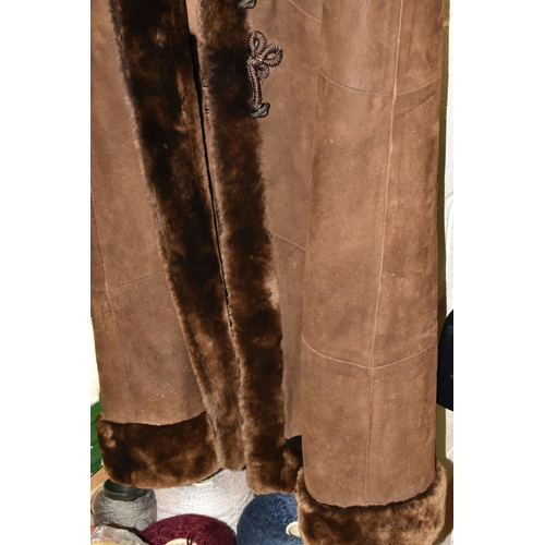 589 - TWO 1970S LADIES' SHEEPSKIN JACKETS, comprising a long brown hooded cape with covered buttons, Frogg... 