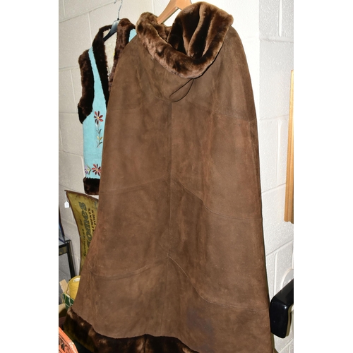 589 - TWO 1970S LADIES' SHEEPSKIN JACKETS, comprising a long brown hooded cape with covered buttons, Frogg... 