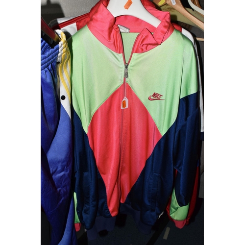 654 - FOUR 1980S TRACK SUITS AND A LUTON FOOTBALL TOP, comprising a new and unused Adidas blue, white and ... 