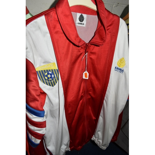 654 - FOUR 1980S TRACK SUITS AND A LUTON FOOTBALL TOP, comprising a new and unused Adidas blue, white and ... 