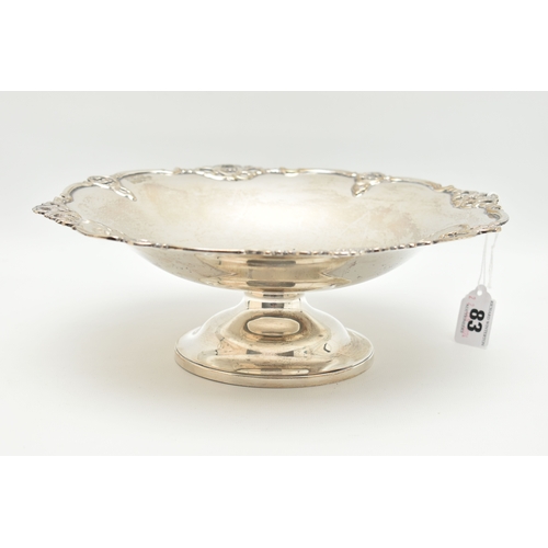 83 - A GEORGE V SILVER FRUIT BOWL, polished bowl decorated with an open work wavy rim, raised on a round ... 