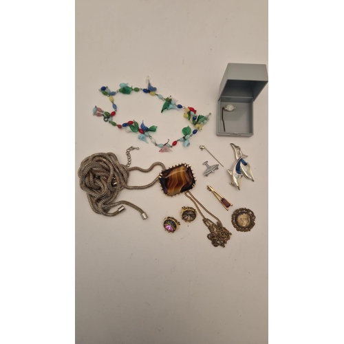 135 - TWO BAGS OF ASSORTED COSTUME JEWELLERY WITH BOOKS, to include a mid 20th century, glass bird necklac... 