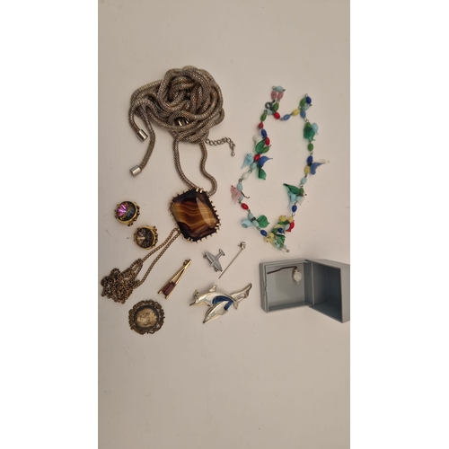 135 - TWO BAGS OF ASSORTED COSTUME JEWELLERY WITH BOOKS, to include a mid 20th century, glass bird necklac... 