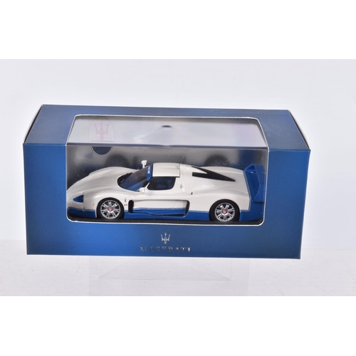 65 - FOUR BOXED DIECAST MODEL VEHICLES, the first is a Maserati MC12 numbered MOC041, Maserati sticker re... 