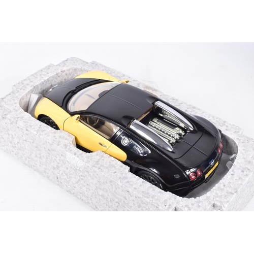 68 - A BOXED DIECAST MODEL 1:18 SCALE BUGATTI EB 16.4 VEYRON SHOWCAR, numbered 70904, in black and yellow... 