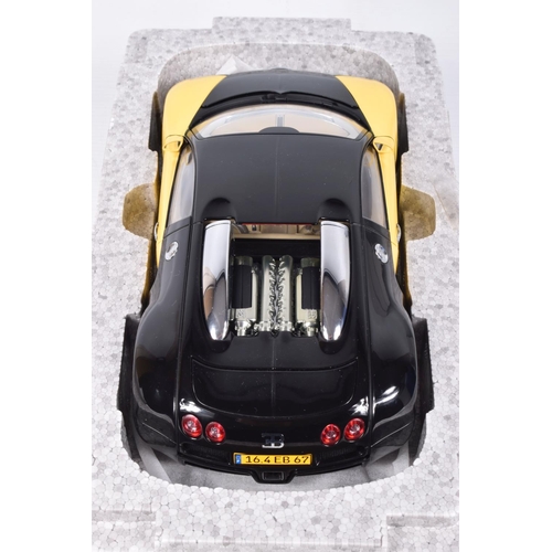 68 - A BOXED DIECAST MODEL 1:18 SCALE BUGATTI EB 16.4 VEYRON SHOWCAR, numbered 70904, in black and yellow... 