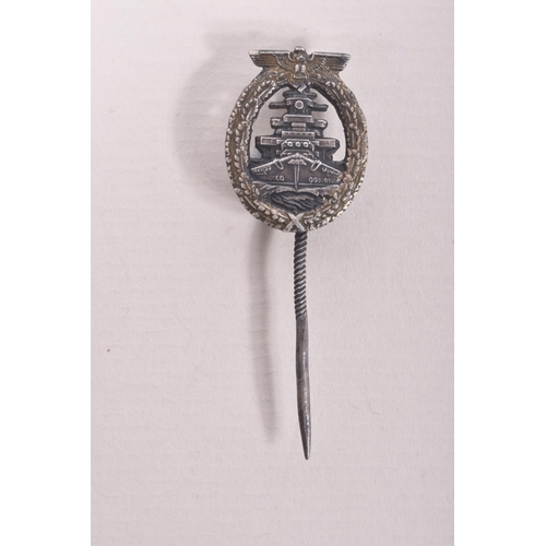 351 - A GERMAN KRIEGSMARINE HIGH SEAS FLEET BADGE AND STICK PIN, the badge has lost some of its finish to ... 