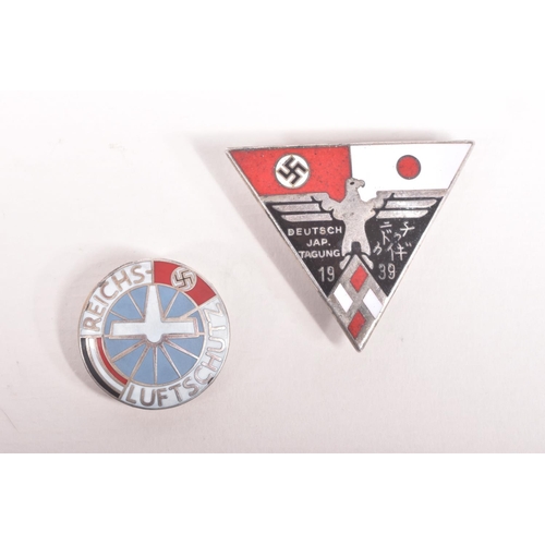 355 - TWO GERMAN PIN BADGES, to include a Luftschutz pin and a 1939 German and Japan alliance pin badge, t... 