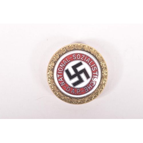 356 - A GERMAN NSDAP BADGE NUMBERED 5204, this features white, red and black enamel all with a garland on ... 