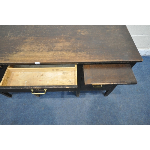 1228 - A 20TH CENTURY OAK DESK, fitted with an arrangement of six drawers and two brushing slides, on squar... 