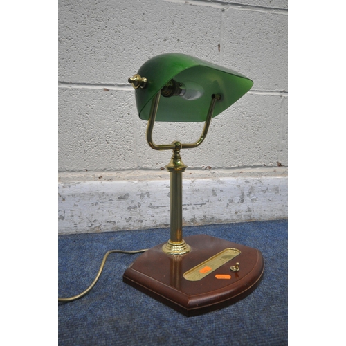 1249 - A BRASS BANKERS LAMP, with a green adjustable shade, on a wooden base fitted with a pen tray