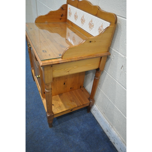 1250 - A MODERN PINE WASH STAND, with a raised tiled back, a glass surface protector, a single dummy drawer... 