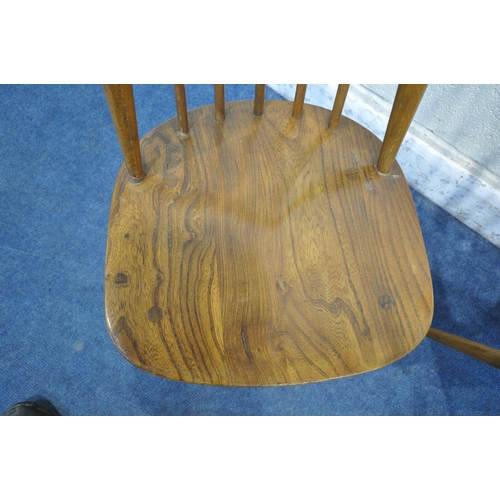 1253 - A SET OF THREE ERCOL ELM AND BEECH GOLDSMITH CHAIRS (condition report: frames with slight wobble, su... 