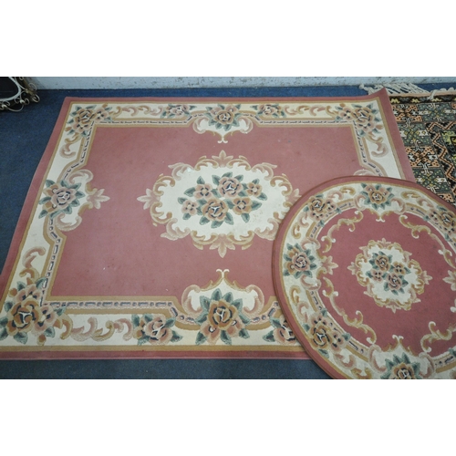 1294 - THREE VARIOUS RUGS, to include a Dunelm pink ground Chinese style rug, with central medallion and ma... 