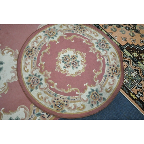 1294 - THREE VARIOUS RUGS, to include a Dunelm pink ground Chinese style rug, with central medallion and ma... 