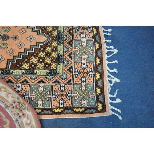 1294 - THREE VARIOUS RUGS, to include a Dunelm pink ground Chinese style rug, with central medallion and ma... 