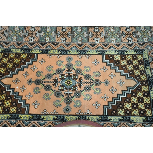 1294 - THREE VARIOUS RUGS, to include a Dunelm pink ground Chinese style rug, with central medallion and ma... 