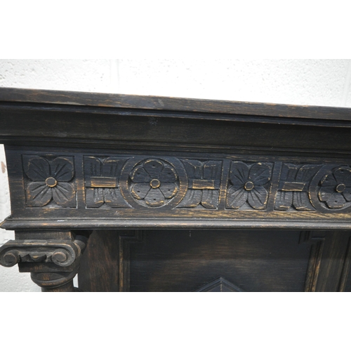 1296 - AN EARLY 20TH CENTURY OAK SIDEBOARD, the raised back with floral carving, geometric panels, on acorn... 